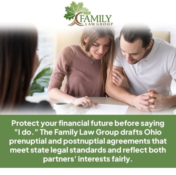 A young couple smiles while reviewing a document with a lawyer or counselor.
