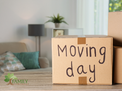 Cardboard boxes with words: moving out and TFLG logo.