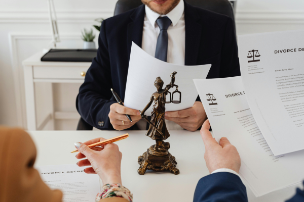 Couple reviewing divorce papers with lawyer.