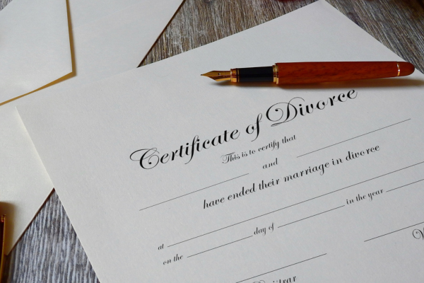 Certificate of divorce papers with pen on table.