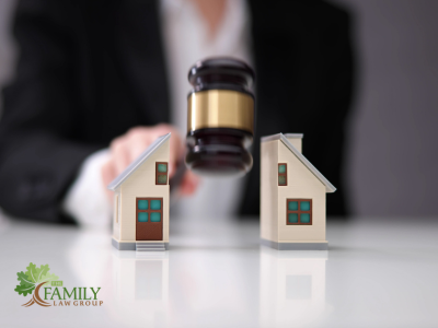 Toy house split in half by gavel. The Family Law Group logo.