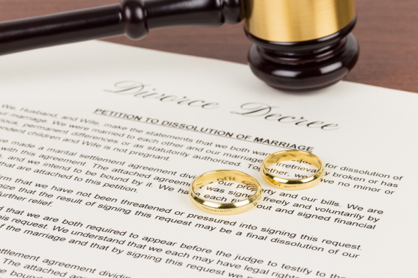 Divorce papers with wedding bands.